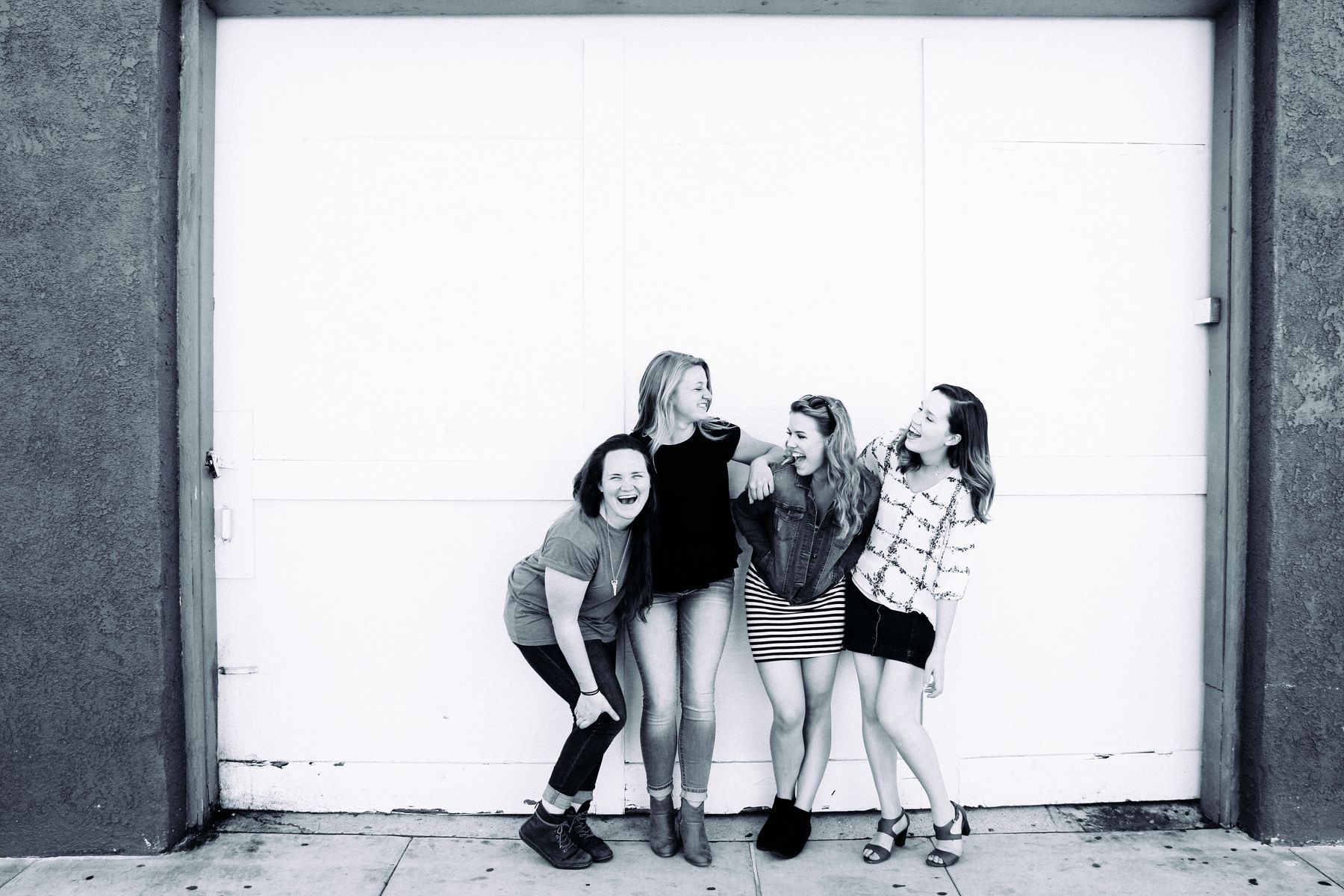 Four friends smiling together