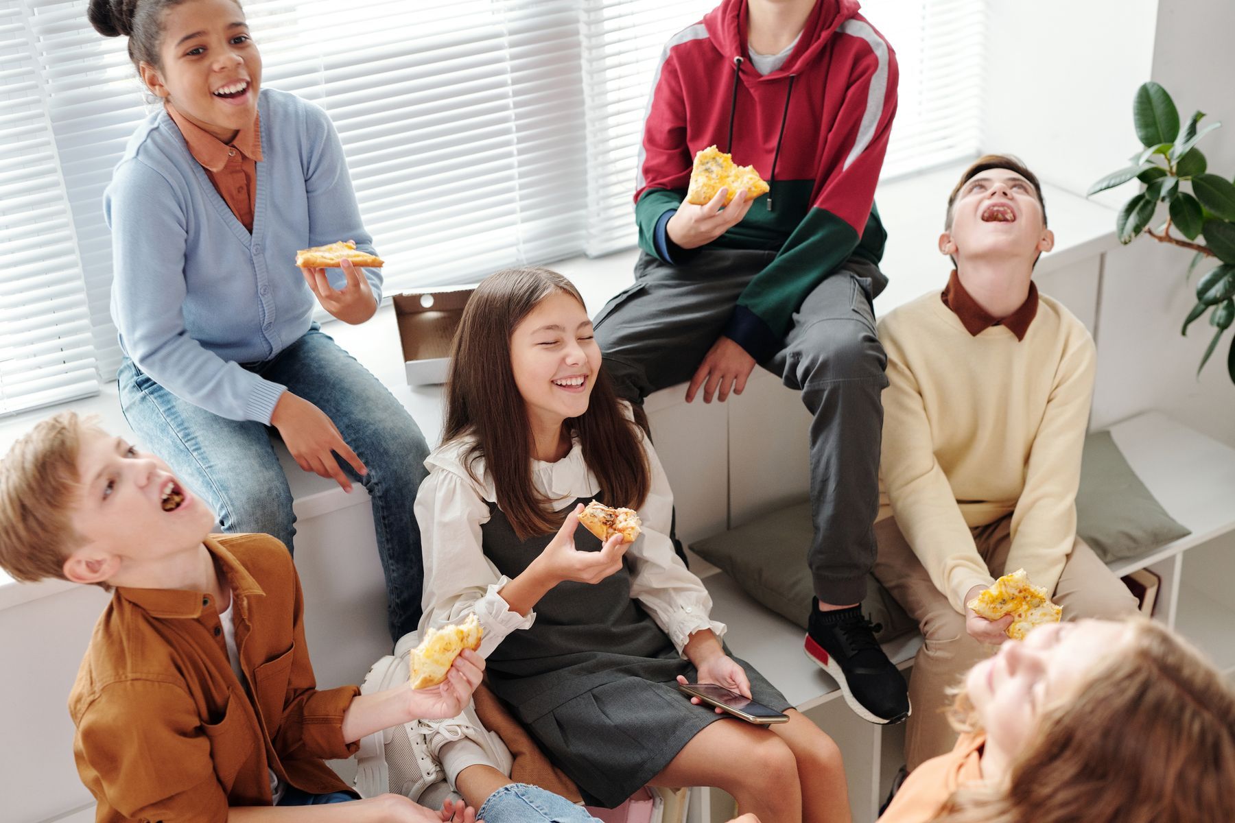 Friends laughing together on a sofa